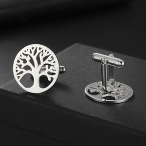 Macro view of silver tree of life cufflinks with hollow round design and bullet back closure