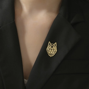 Modern geometric wolf head brooch in gold stainless steel on a black suit lapel