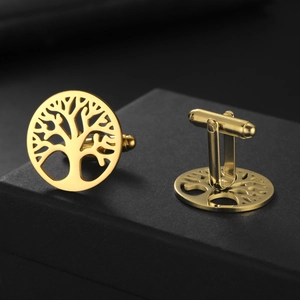 Close-up of golden Tree of Life cufflinks with cutout design and polished finish