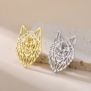 Detail of hollow geometric wolf head pins in polished gold and silver stainless steel finish