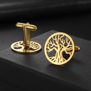 Detail of gold tree of life cufflinks on a black textured display case