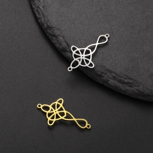 Detailed macro of 18k gold and silver plated Celtic witch knot stainless steel pendants
