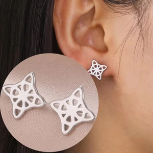 Detailed macro view and model shot of silver stainless steel Celtic witch knot earrings
