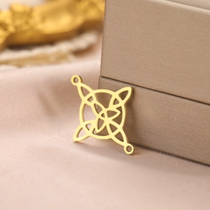 Detail of 18k gold plated stainless steel Celtic knot pendant on silk background