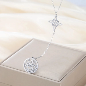 Macro detail of stainless steel Wiccan pendant with pentagram and Celtic knot design