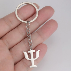 Polished stainless steel Psi symbol keychain held in hand for size visualization