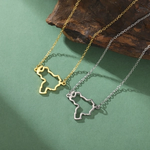 Detail of hollowed-out map pendants in gold and silver finish with fine O-chains
