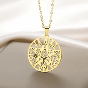 Macro shot of gold stainless steel pendant featuring engraved pentagram and occult symbols
