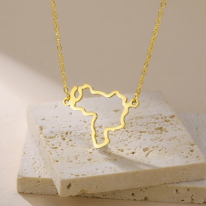 Detail of gold-plated stainless steel hollow map pendant on a minimalist chain