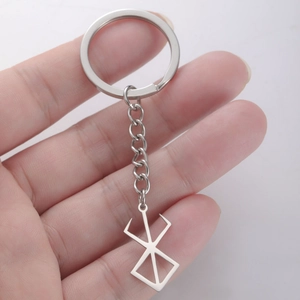 Close-up of hand holding a silver stainless steel Berserk Brand of Sacrifice keychain