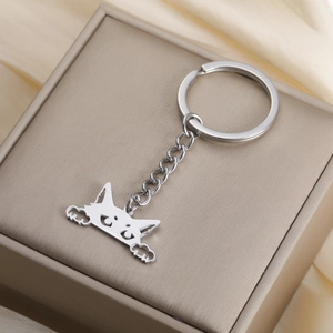 Macro view of cute cartoon cat pendant keychain on a luxury silk jewelry gift box