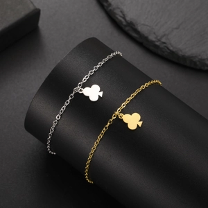 Minimalist clover pendant bracelet in gold and silver finish on a display stand