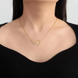 Close-up of golden stainless steel hollow heart Venezuela map pendant necklace on model