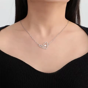 Detail of silver hollow map pendant with heart on O-chain worn by a model