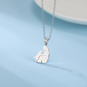 Polished stainless steel necklace featuring a girl hugging her dog silhouette pendant