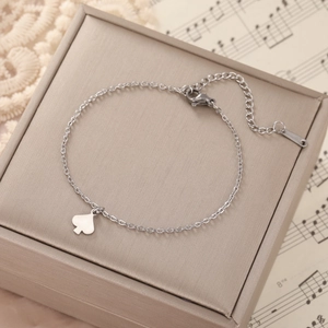 Detailed shot of silver heart shell pendant bracelet on an elegant jewelry gift box