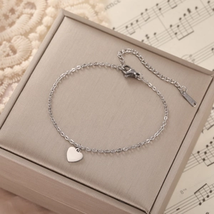 Detail of 304 stainless steel heart pendant bracelet with lobster clasp on jewelry box