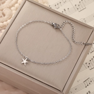 Macro detail of silver starfish pendant bracelet with adjustable chain and lobster clasp
