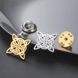 Minimalist Celtic knot brooch in gold and silver stainless steel finish on dark background