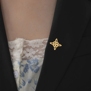 Elegant gold double-layered witches knot brooch in stainless steel on black blazer lapel