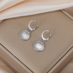 Detail of silver leverback earrings with elegant shell charms on silk fabric