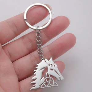 Detail of horse head keychain with Celtic knot pattern in polished stainless steel