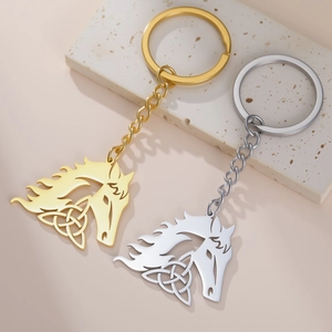 Detailed close-up of horse head keychains with Celtic knot patterns in gold and silver finish