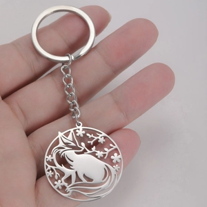 Polished 304 stainless steel keychain with fox and floral cutout design held by hand