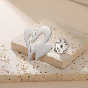 Modern double heart hollow brooch in silver stainless steel on minimalist stone base