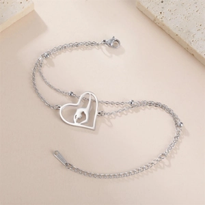 Women's double-chain stainless steel heart bracelet featuring a gymnast dancer silhouette