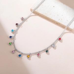 Macro view of colorful zircon charms on a polished stainless steel chain necklace