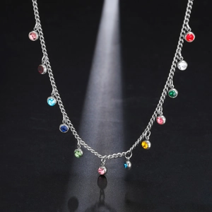 Detailed macro of silver stainless steel necklace featuring colorful round zircon stones