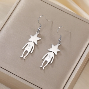 Detail macro view of cute 304 stainless steel star-headed alien drop earrings on silk