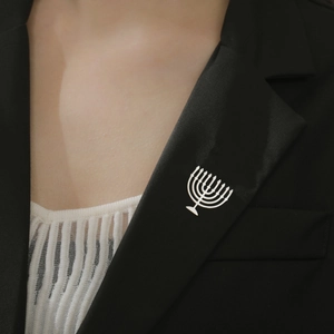 Silver stainless steel Menorah brooch pin accessory on a classic black suit lapel