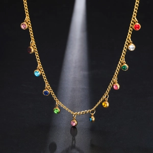 Detailed close-up of golden stainless steel necklace with twelve colorful round gemstones