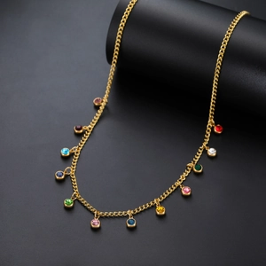 Detail shot of golden stainless steel necklace featuring twelve vibrant colorful crystal charms