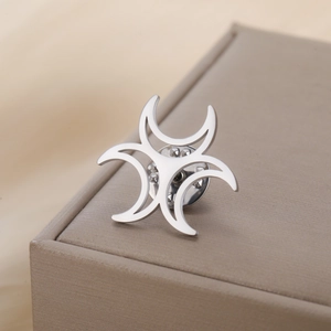 Detailed view of silver stainless steel cross brooch with butterfly clasp on leather box