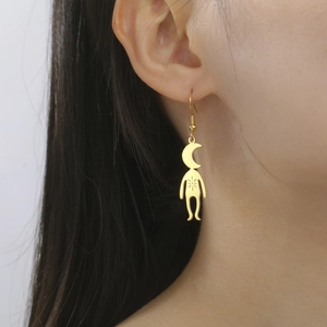 Close-up of gold stainless steel humanoid earrings with moon and star details