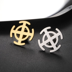 Macro shot of gold and silver stainless steel hollow cross brooches with metallic finish