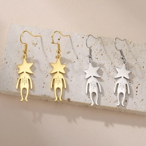 Detail view of gold and silver alien star pendants on textured natural stone background