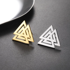 Macro detail of polished gold and silver Valknut symbol stud earrings in 304 stainless steel