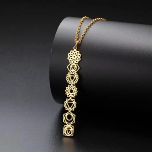 Gold stainless steel 7 chakras mandala vertical bar pendant necklace on a jewelry stand