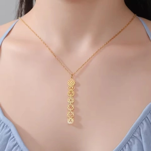Detailed close-up of 304 stainless steel golden necklace with seven chakra symbols