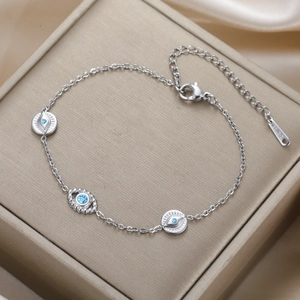 Macro shot of stainless steel Evil Eye bracelet with blue zircon inlay on jewelry box