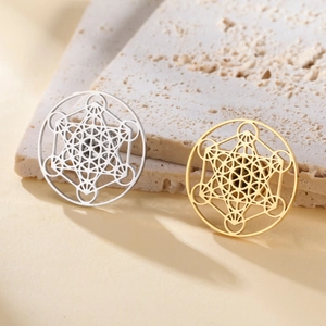 Detailed view of hollow Metatron's Cube brooches in gold and silver stainless steel