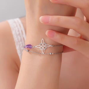 Detail of double-layer stainless steel bracelet with witch knot and purple amethyst stone