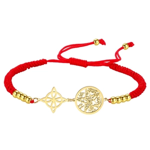 Detail of red braided cord bracelet featuring golden witch knot and pentagram charms