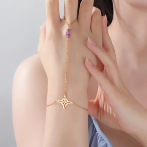 Detail of gold slave bracelet featuring purple amethyst stones and Celtic knot design