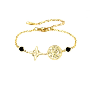 Detail of gold stainless steel bracelet with witch knot pendant and black beads