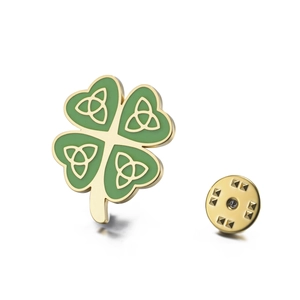 Golden four leaf clover brooch with green enamel and Celtic knot pattern on white background